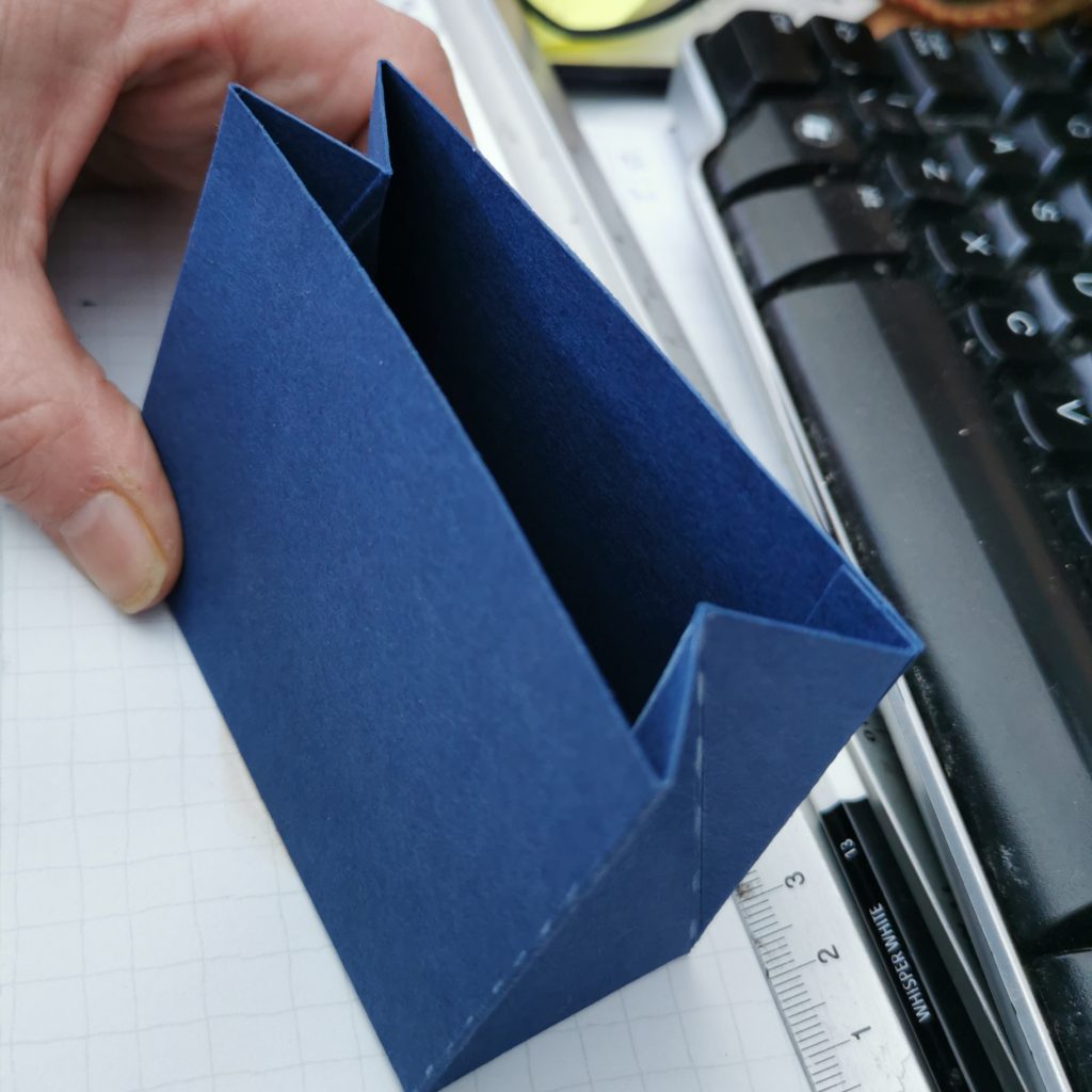 The small triangular bag with fold in sides