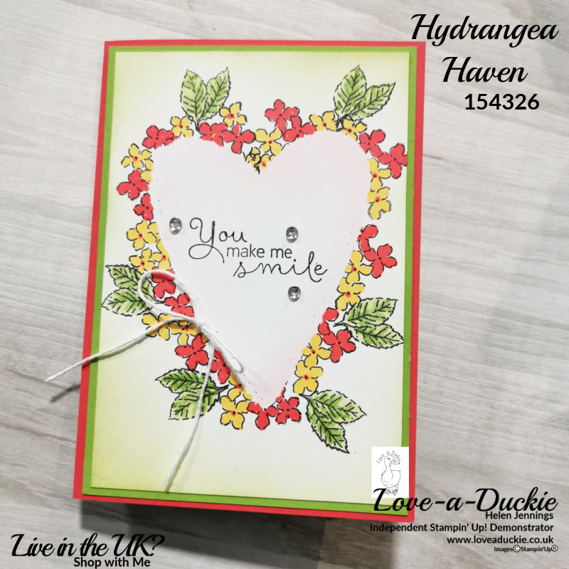 A floral heart shaped card that has used masking techniques for colour blending and stamping