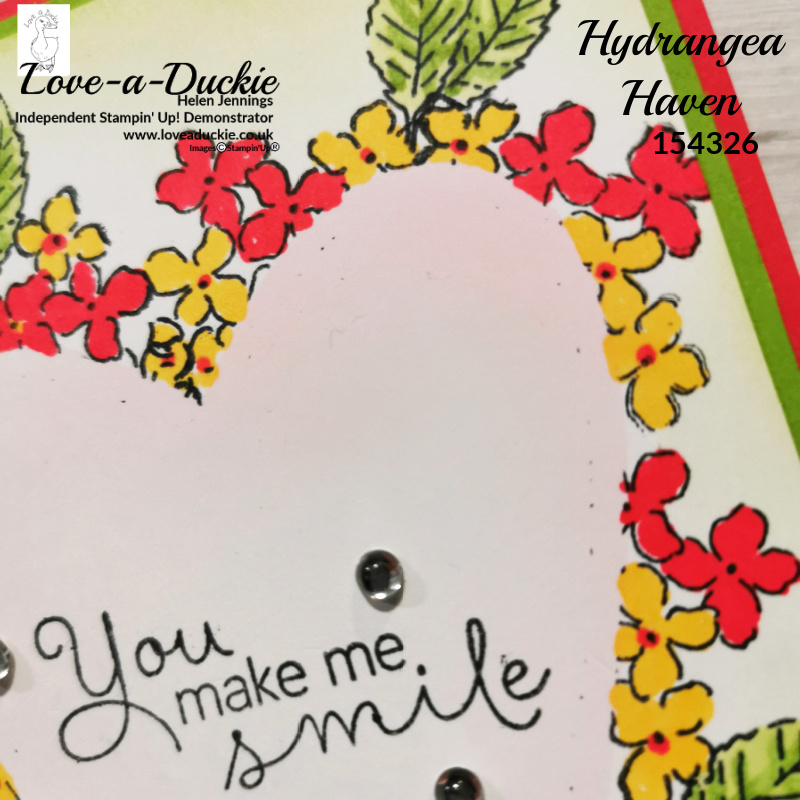 This card has used masking to create a soft colour on the inside of the floral heart and stamping around the edge of the heart.