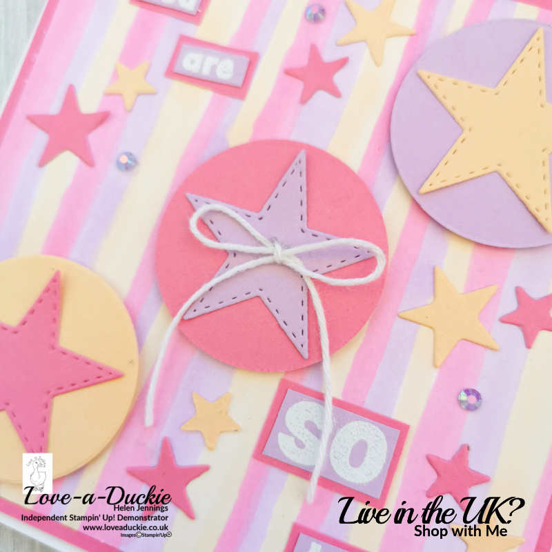 The stitched circle on this card sits on a die cut circle with a striped background.
