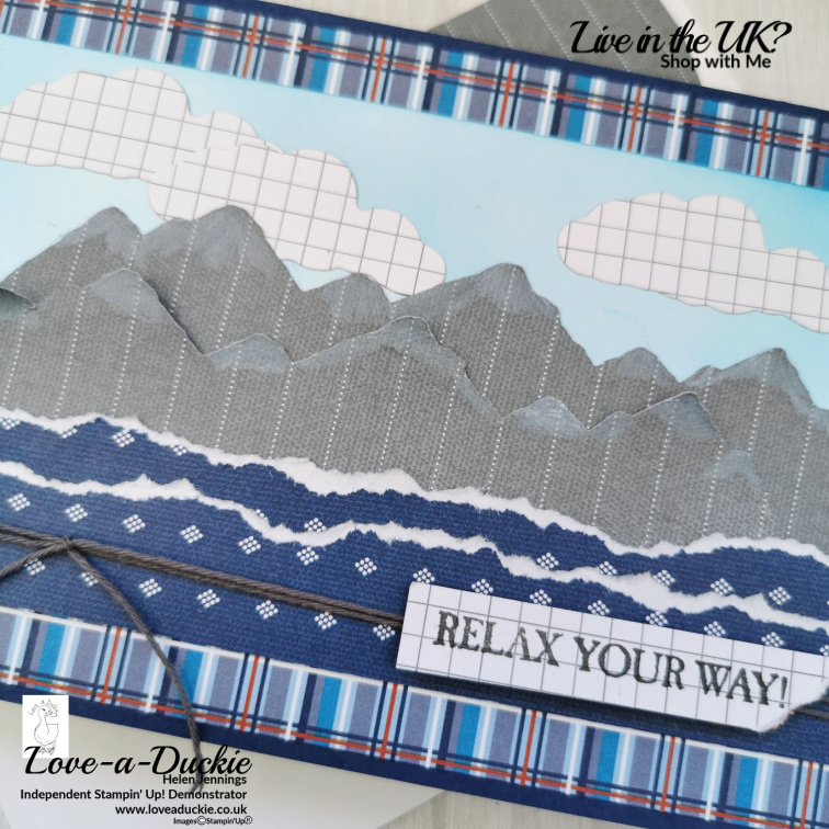 Watercolor pencil is used to add detail to these die cut, patterned paper mountains.
