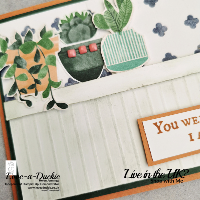 This faux wood panelling has been created by scoring the card and then sponging it with ink.