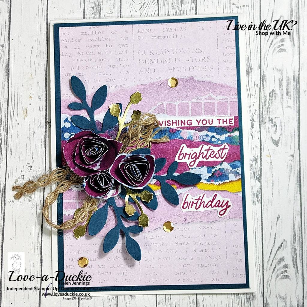 A card using torn paper flowers created from patterned paper.