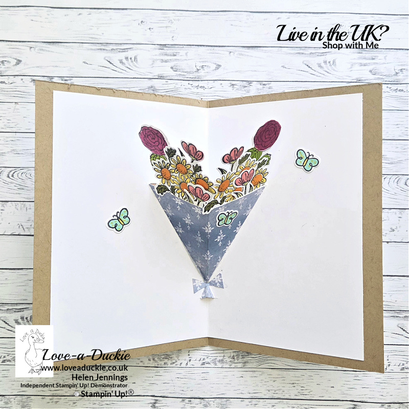 Handmade pop up card featuring a stamped floral bouquet from the Pop Up Petals bundle, arranged inside a triangular wrap with butterflies, creating a dimensional pop up effect when the card is opened.