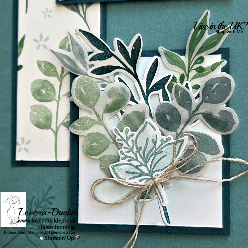 Close-up detail of layered die-cut foliage created using washi tape and botanical stamps, tied with natural twine on a handmade Thinking of You card.