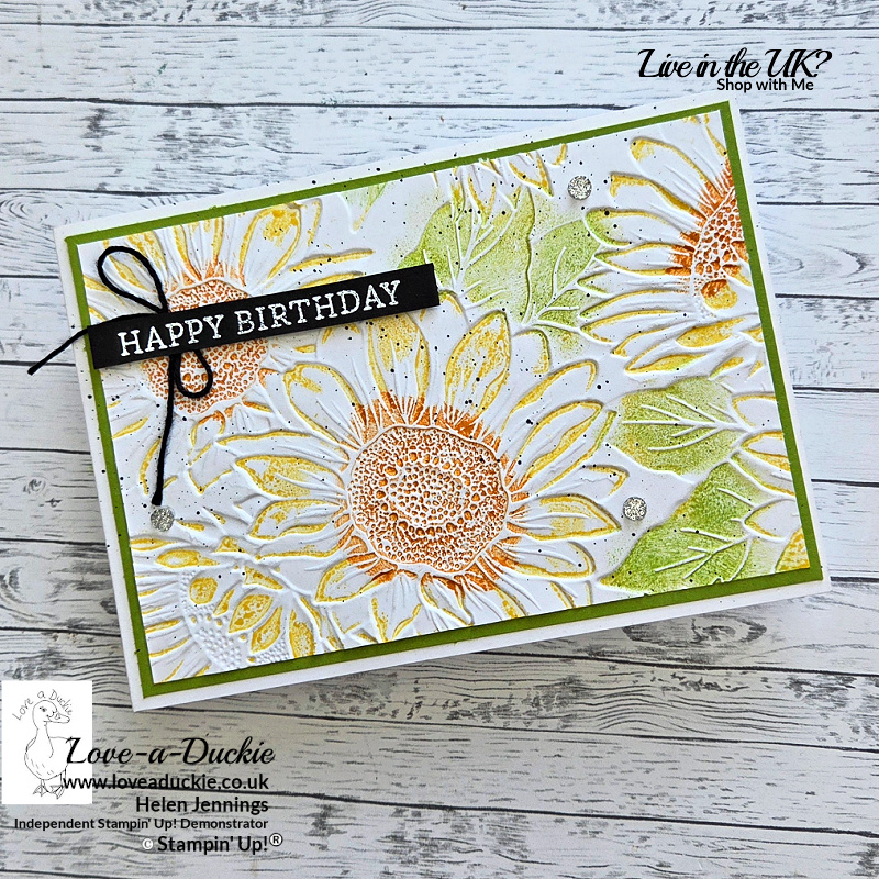 Landscape handmade birthday card with a textured sunflower background created using a 3D embossing folder and letterpress inking technique. The white embossed panel is coloured in yellow, green and orange tones and layered onto a Granny Apple Green mat. A black sentiment strip and silver embellishments complete the design.