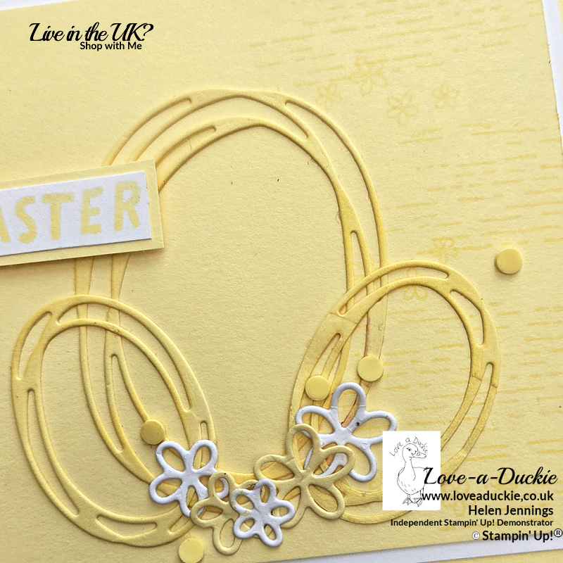 Close-up of handmade monochromatic Easter card featuring stylised Easter eggs die cut from Lemon Lolly cardstock using Swirled Design Dies. The eggs are blended with Lemon Lolly ink and decorated with small die cut flowers and yellow embellishment dots.