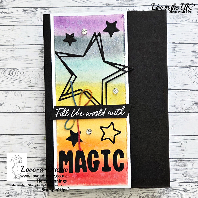 Rainbow watercolour handmade card with black die-cut stars and “Magic” sentiment